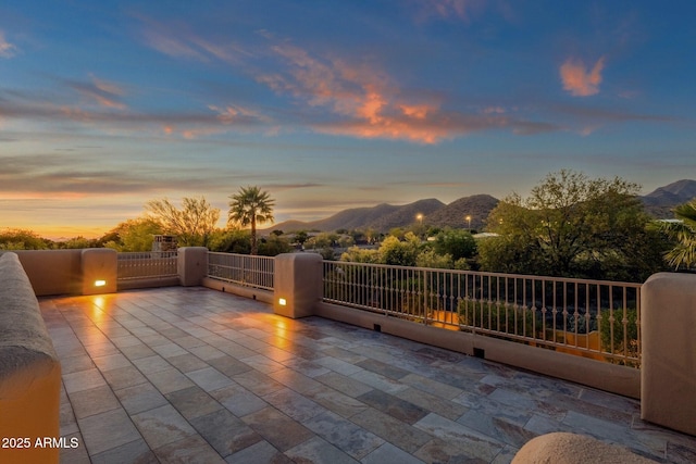 patio terrace at dusk with a mountain view