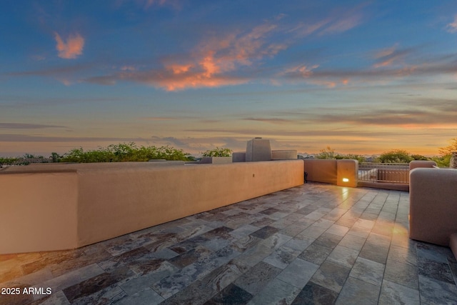 view of patio terrace at dusk