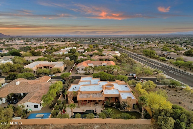aerial view at dusk featuring a residential view
