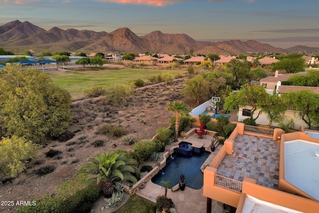 aerial view at dusk featuring a mountain view