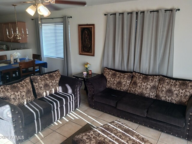 7118 S 37th Gln, Phoenix, AZ 85041 - living room featuring light tile patterned flooring, a ceiling fan, and a chandelier