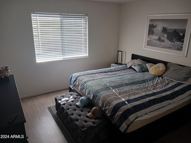 7118 S 37th Gln, Phoenix, AZ 85041 - bedroom featuring wood finished floors and baseboards
