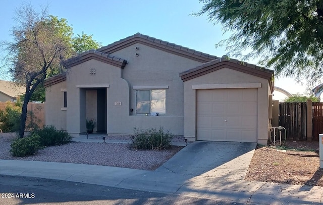 7118 S 37th Gln, Phoenix, AZ 85041 - mediterranean / spanish house featuring a garage, stucco siding, concrete driveway, and a tiled roof