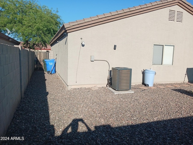 7118 S 37th Gln, Phoenix, AZ 85041 - view of side of property featuring central air condition unit, stucco siding, and a tile roof