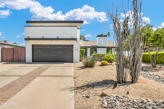 5435 E Cambridge Ave, Phoenix, AZ 85008 - view of front of home featuring concrete driveway, a garage, stucco siding, and a chimney