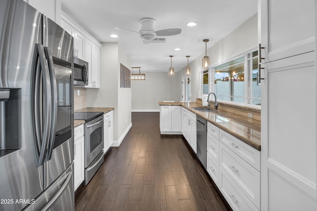 5435 E Cambridge Ave, Phoenix, AZ 85008 - kitchen featuring appliances with stainless steel finishes, ceiling fan, white cabinets, dark wood-style floors, and recessed lighting
