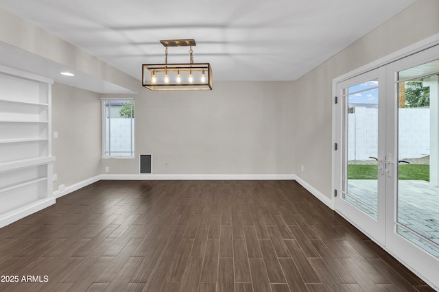 5435 E Cambridge Ave, Phoenix, AZ 85008 - empty room with french doors, built in shelves, and dark wood-style flooring