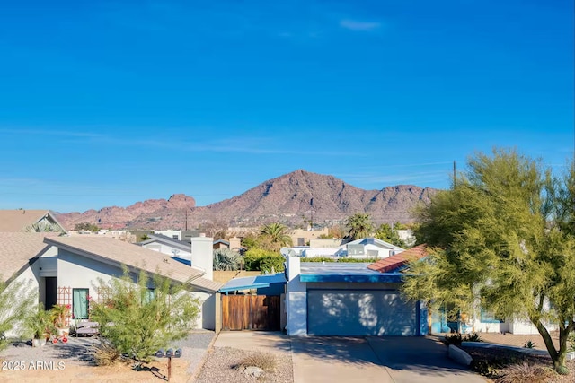 5435 E Cambridge Ave, Phoenix, AZ 85008 - view of front of property featuring a mountain view, an attached garage, concrete driveway, and stucco siding