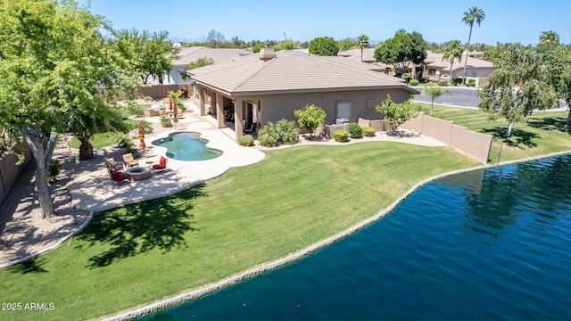 view of swimming pool featuring a water view, an outdoor fire pit, a patio area, and a lawn