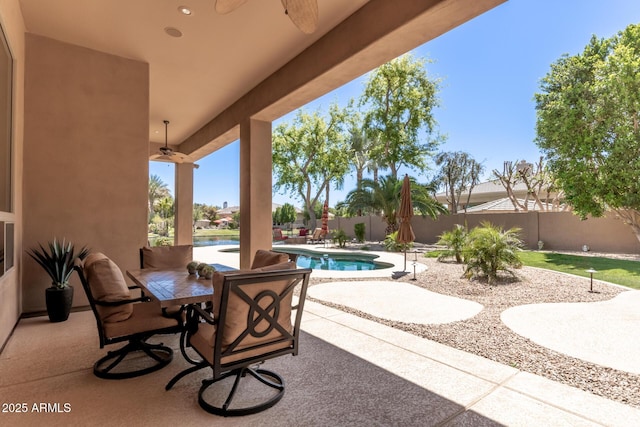 view of patio featuring a fenced in pool and ceiling fan