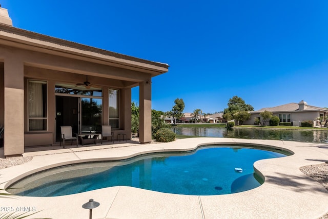 view of pool featuring a water view, ceiling fan, and a patio area