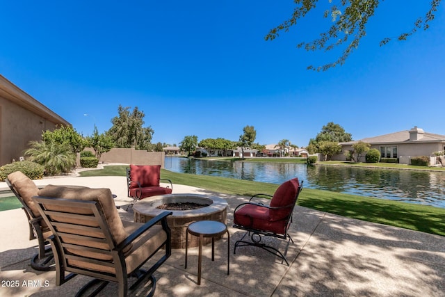 view of patio featuring a water view and an outdoor fire pit