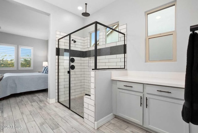 full bathroom with ensuite bath, a tile shower, and wood finish floors