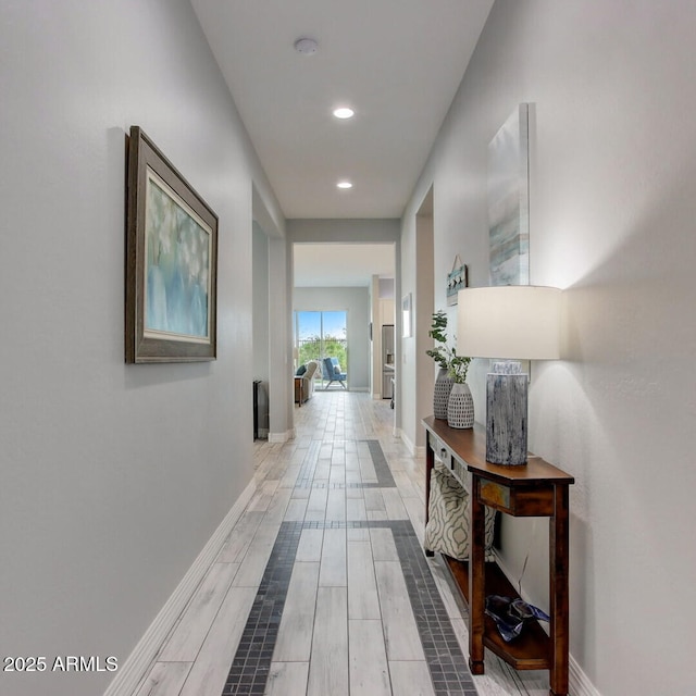 hall with baseboards, wood finished floors, and recessed lighting