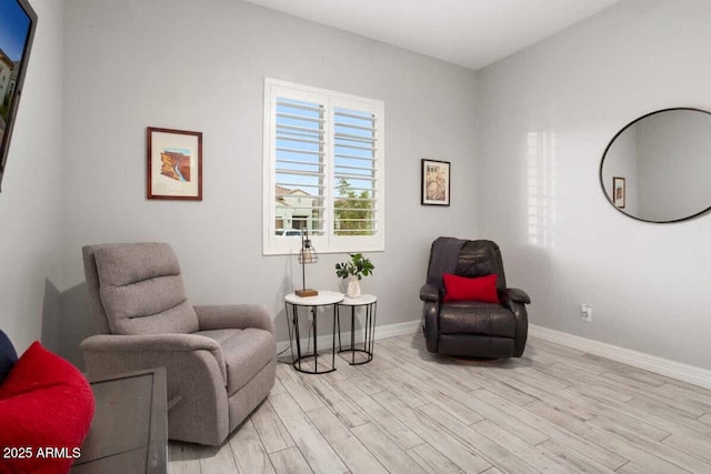 living area with light wood-style floors and baseboards