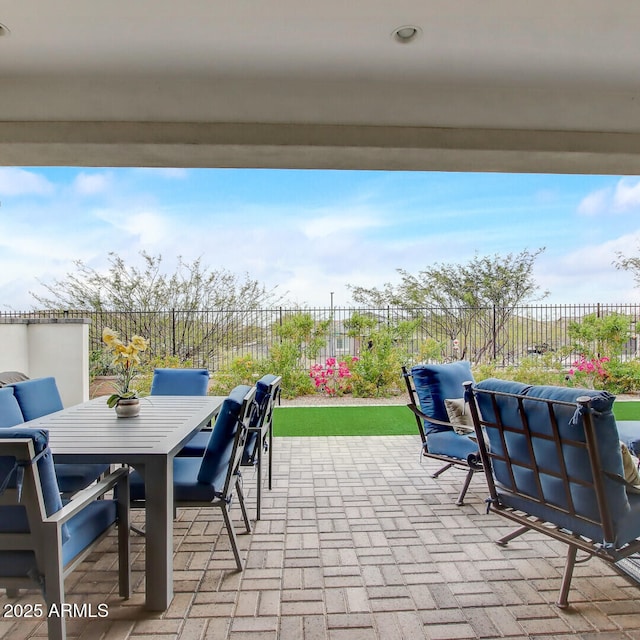 view of patio with outdoor dining space and a fenced backyard