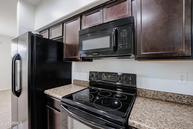 kitchen featuring dark brown cabinetry and black appliances