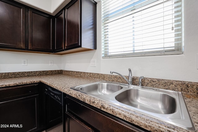 kitchen featuring sink, dark brown cabinets, and black dishwasher