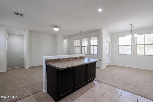 kitchen featuring a chandelier, hanging light fixtures, and light colored carpet