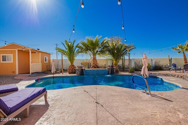 view of swimming pool featuring a fenced in pool, a patio, an outbuilding, and a fenced backyard