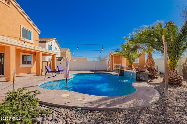 view of swimming pool featuring a fenced in pool, a patio, an outbuilding, and a fenced backyard