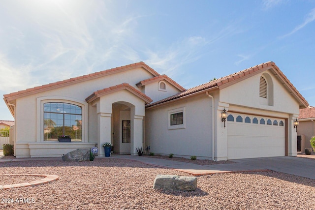 mediterranean / spanish house featuring a garage