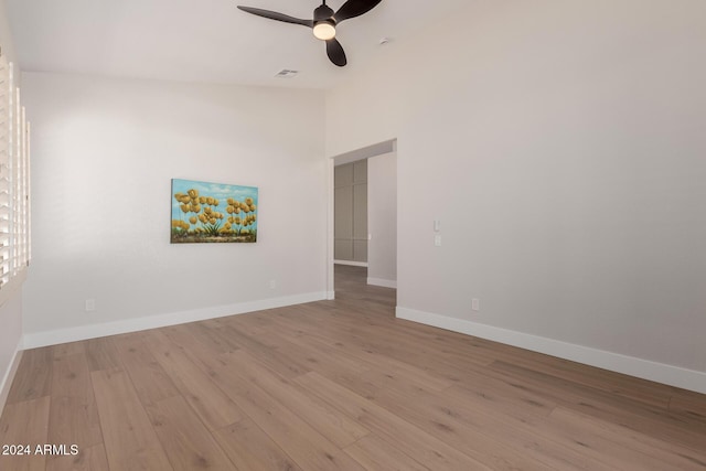 empty room featuring ceiling fan, high vaulted ceiling, and light hardwood / wood-style floors