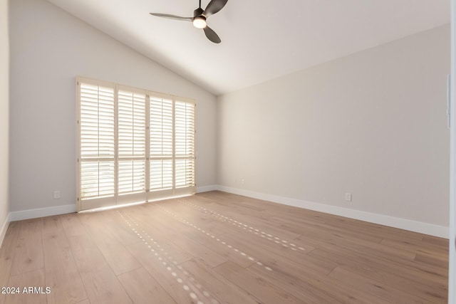 empty room with ceiling fan, light wood-type flooring, and high vaulted ceiling