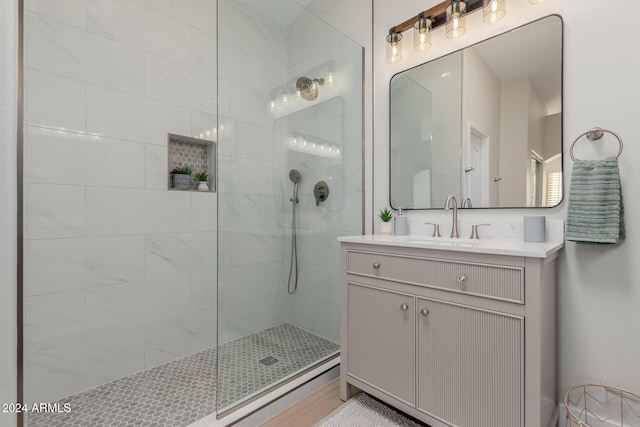 bathroom with vanity and tiled shower