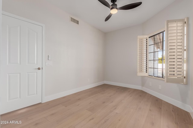 empty room with light hardwood / wood-style flooring and ceiling fan