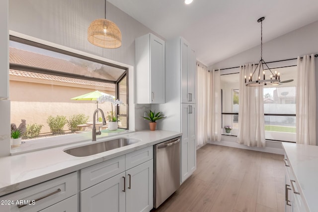 kitchen with sink, stainless steel dishwasher, light hardwood / wood-style floors, vaulted ceiling, and white cabinets