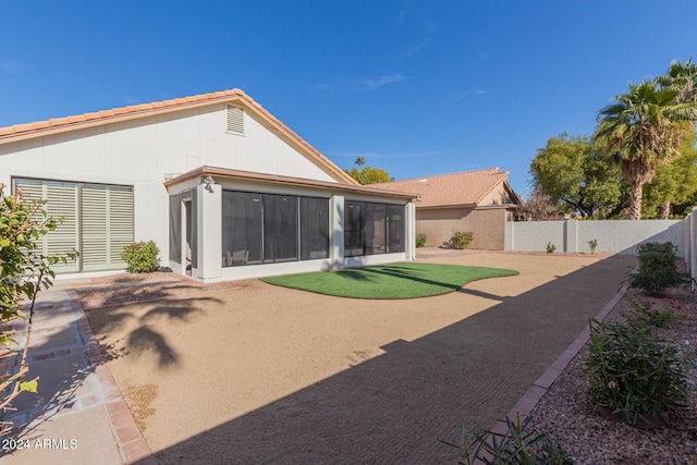 back of house featuring a patio and a sunroom