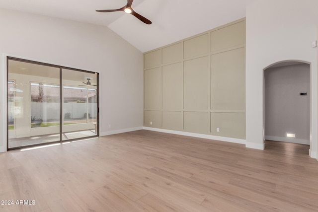 unfurnished living room featuring high vaulted ceiling, light hardwood / wood-style flooring, and ceiling fan