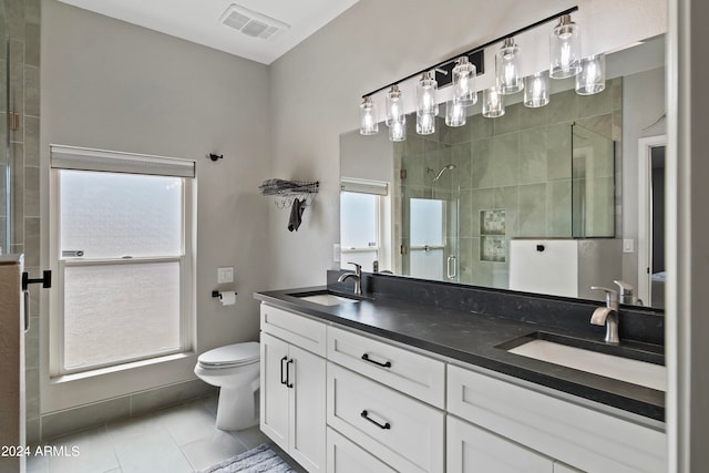 bathroom with vanity, toilet, tile patterned floors, and an enclosed shower