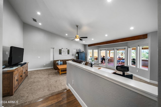 living room featuring ceiling fan, dark wood-type flooring, and vaulted ceiling