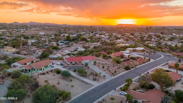 aerial view at dusk featuring a mountain view