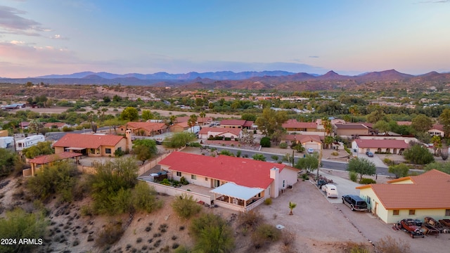 aerial view at dusk featuring a mountain view