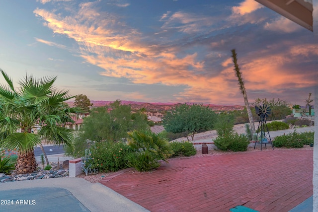 patio terrace at dusk featuring a deck