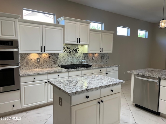 kitchen with white cabinetry, appliances with stainless steel finishes, decorative light fixtures, and decorative backsplash