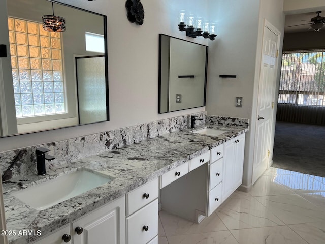 bathroom with vanity, ceiling fan, and a healthy amount of sunlight