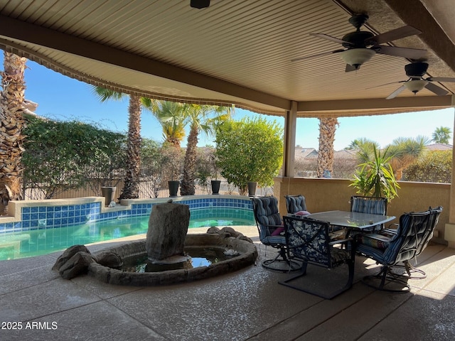 view of patio / terrace with a fenced in pool and ceiling fan