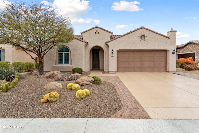 mediterranean / spanish home with a garage