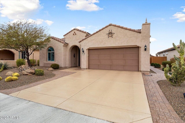 mediterranean / spanish-style house with a garage