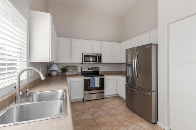 1713 N Sinova, Mesa, AZ 85205 - kitchen featuring stainless steel appliances, light countertops, white cabinetry, and a sink