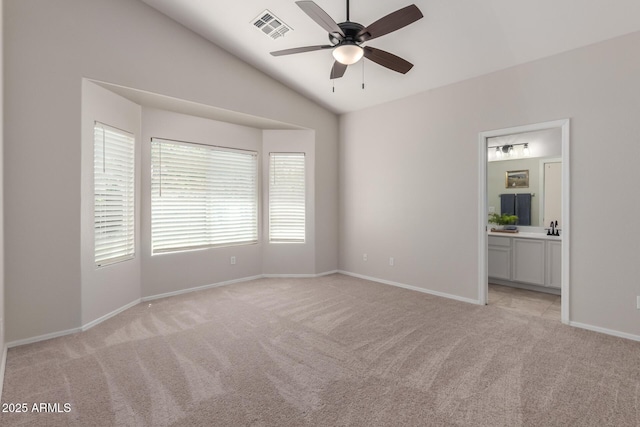 1713 N Sinova, Mesa, AZ 85205 - unfurnished bedroom with visible vents, baseboards, ensuite bath, vaulted ceiling, and light colored carpet