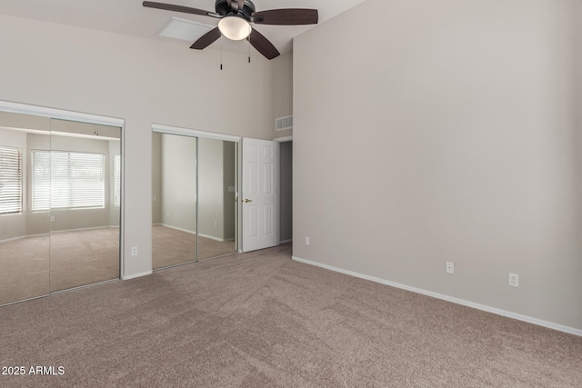 1713 N Sinova, Mesa, AZ 85205 - unfurnished bedroom featuring two closets, baseboards, carpet, and a towering ceiling