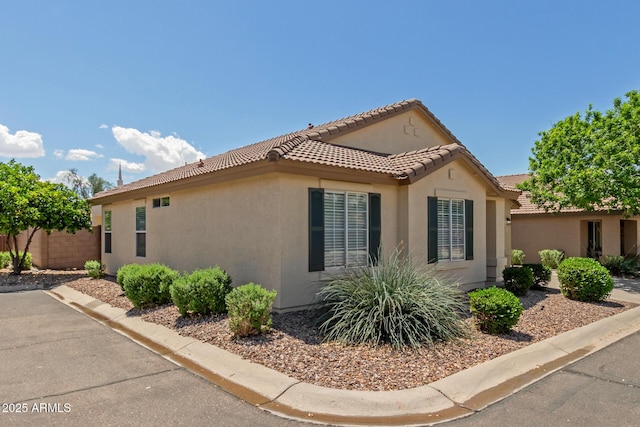 1713 N Sinova, Mesa, AZ 85205 - view of property exterior with stucco siding, fence, and a tile roof