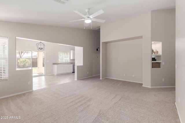1713 N Sinova, Mesa, AZ 85205 - unfurnished living room featuring a ceiling fan, visible vents, light carpet, a sink, and baseboards