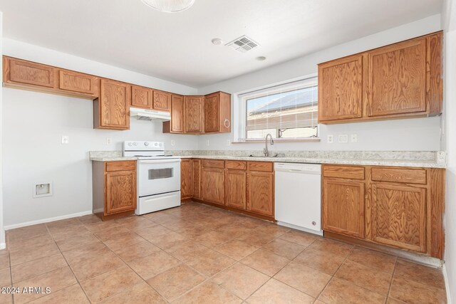 kitchen featuring sink, white appliances, and light tile patterned flooring