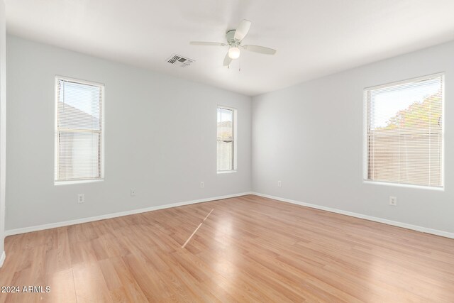 unfurnished room with ceiling fan and light wood-type flooring